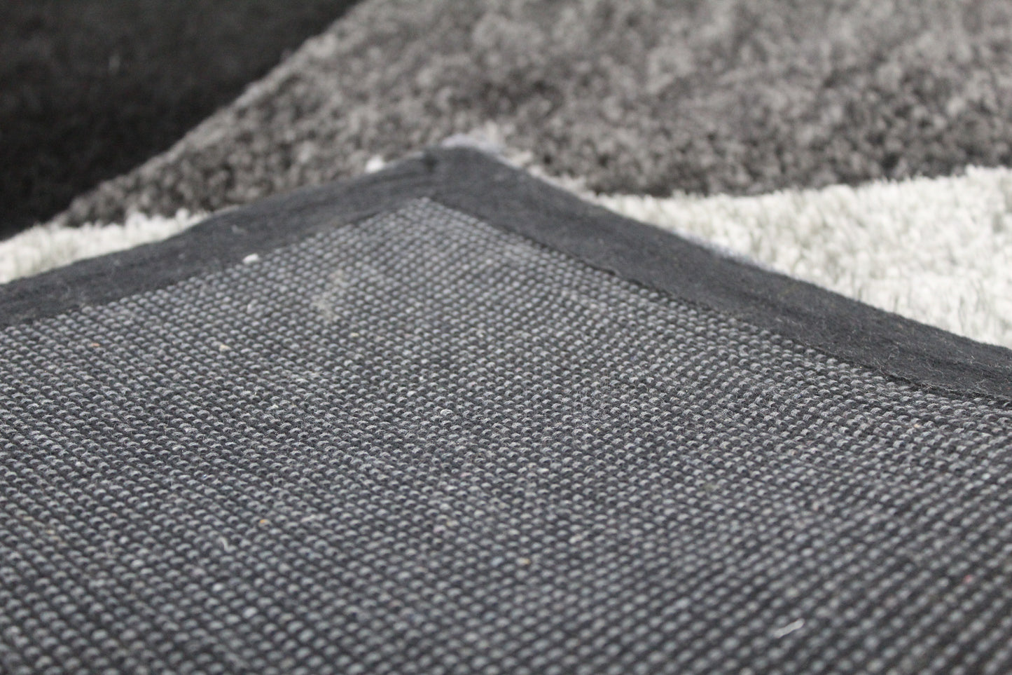 Shaggy diamond rug in black & grey. Soft, plush, and modern with a bold geometric design – perfect for living rooms, bedrooms, or offices.