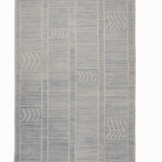 Textured blue and beige patterned rug on a white background